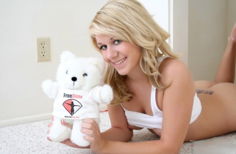Cute blond Ashlee shows her tiny tits and bald slit with help from a plush toy 29816666