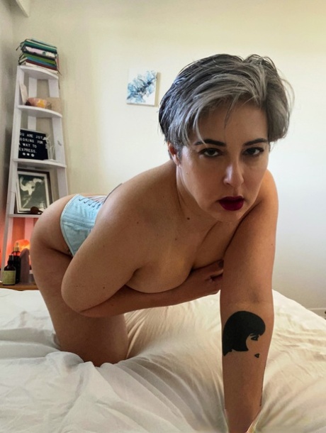 Older platinum blonde Seska masturbates with a toy on her bed in tan stockings 16968871